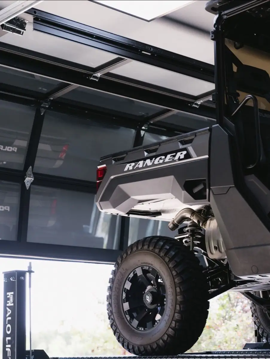 Utility vehicle raised on a garage car lift