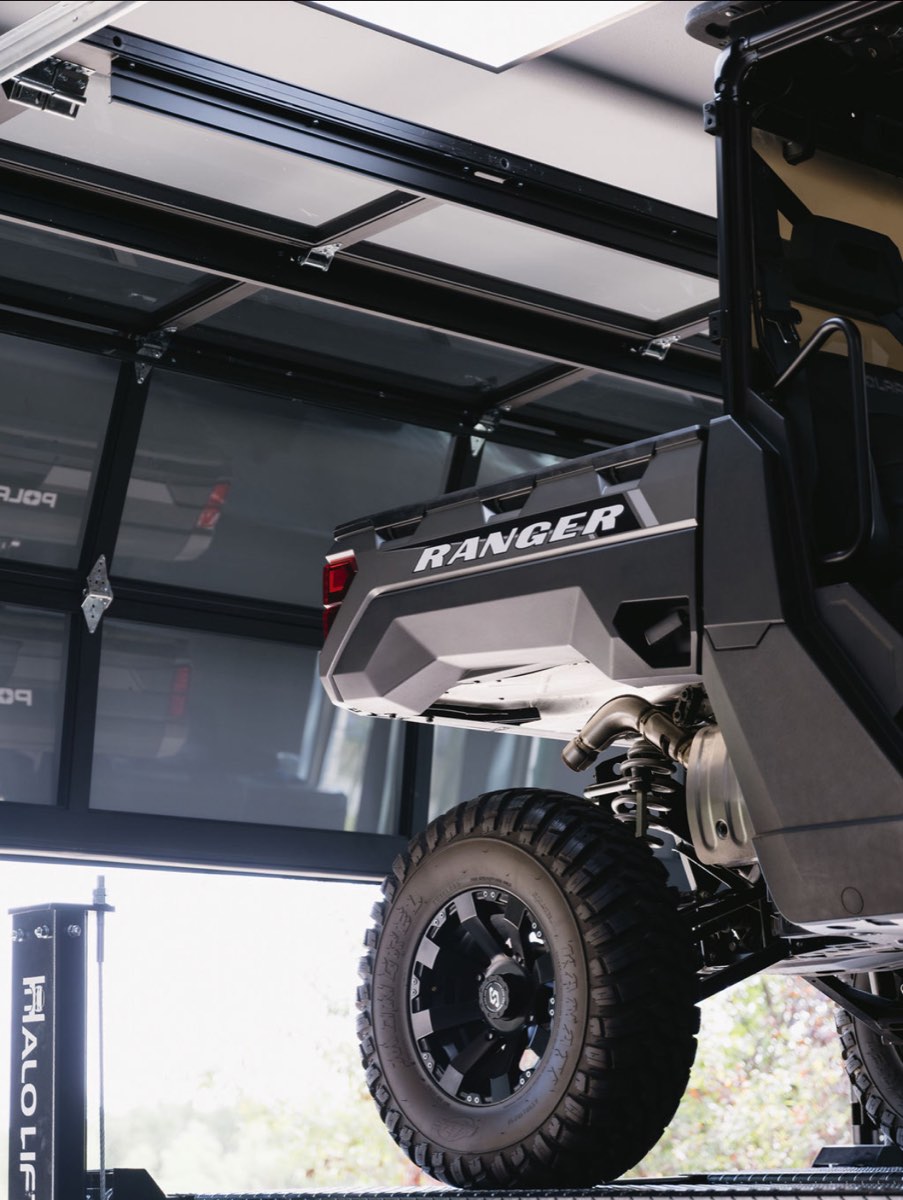 Utility vehicle raised on a garage car lift