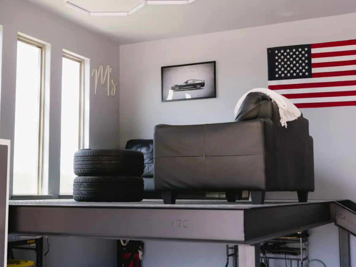 Raised garage lounge platform with seating and tire storage